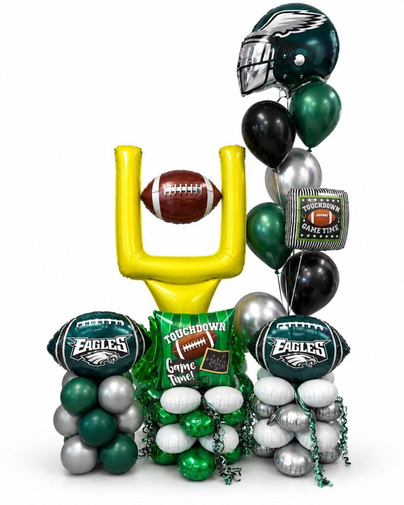 Football balloon arrangement with goalpost and green and black helmet balloons for an Eagles game day party